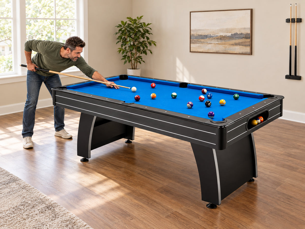 Pool Table Built, a man executing a side-rail shot with comfortable clearance between his cue and the wall