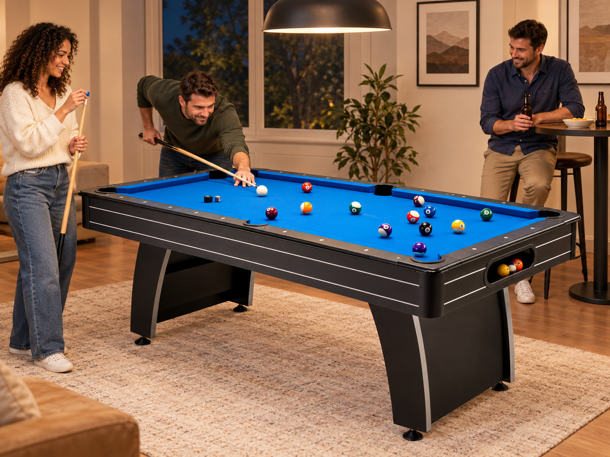 Pool Table Built, a small group rotating turns around the table, one person chalking a cue while another lines up a shot
